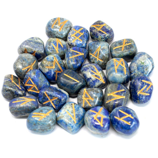 Blue, polished stones show gold rune-like symbols, scattered over a bright white surface.