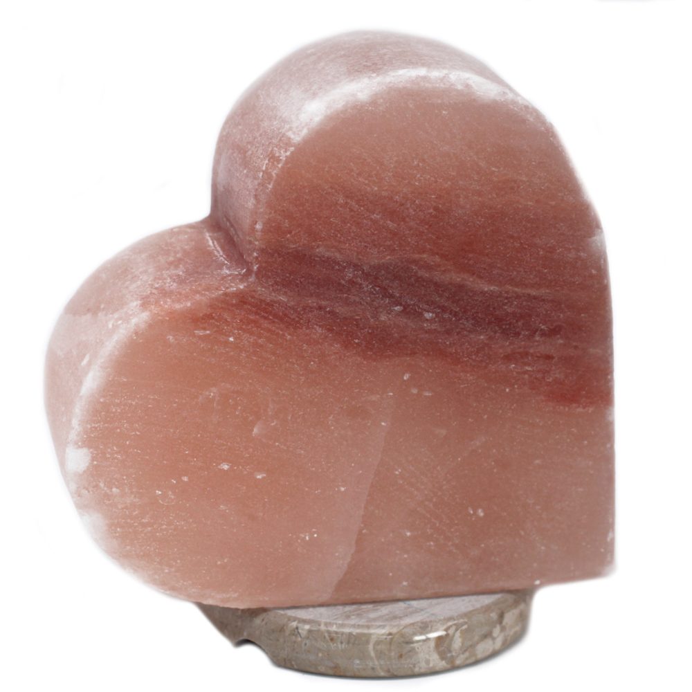 A pink, heart-shaped rock rests on a round, flat base, set against a plain white background.