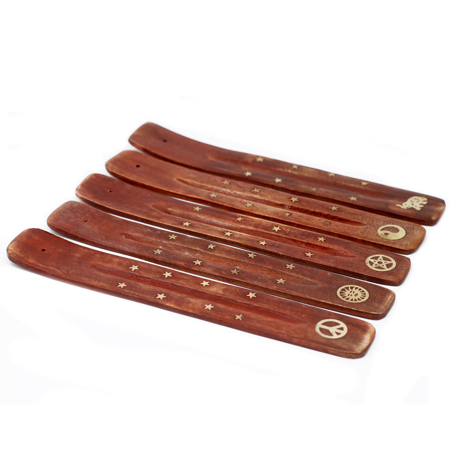 Wooden incense holders with golden star designs and varied symbols—elephant, yin yang, pentagram, sun, peace sign—are arranged in a fan shape on a white surface.
