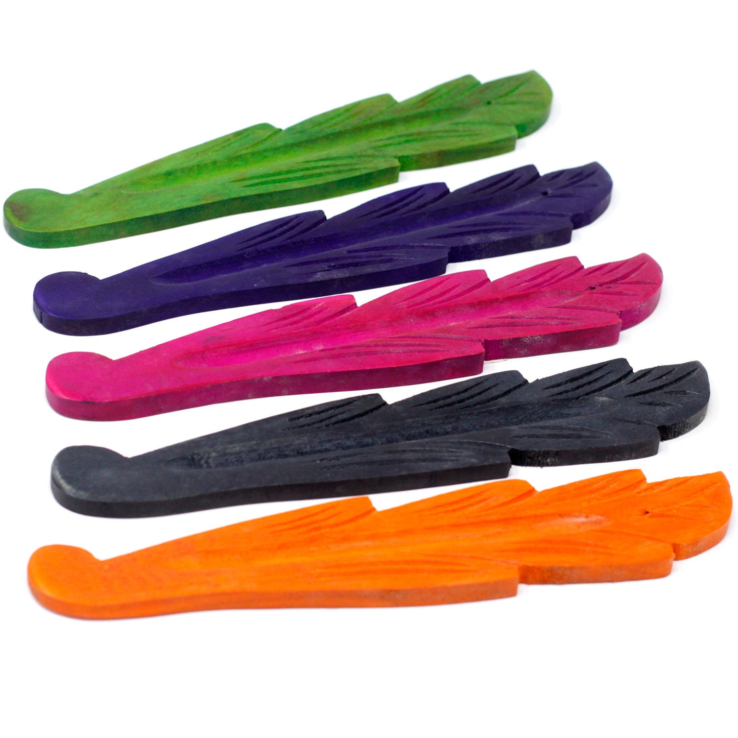 Vibrantly colored, feather-shaped incense holders are stacked in six colors—green, purple, pink, black, orange, and red—arranged diagonally on a white background.