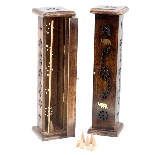 Wooden incense holder with an open compartment holds a stick and cone incense. Decorative carvings, including floral motifs and an elephant, adorn its surface. Nearby, several cone incenses are placed.