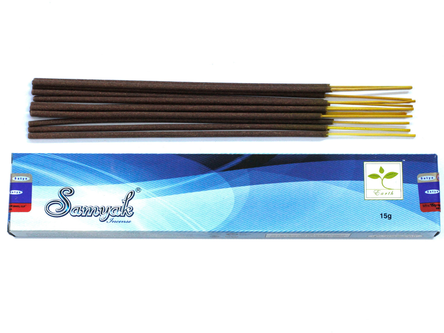 Incense sticks lie above a blue and white box labeled “Samyak Incense” with a small leaf logo and the word “Earth.” The box weighs 15g.