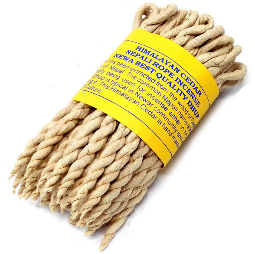 A bundle of twisted ropes wrapped in a yellow label with blue text: “Himalayan Cedar Nepali Rope Incense Newa Best Quality Dhup.” Positioned against a neutral white background.