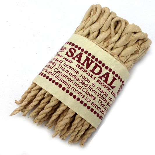 A bundle of twisted sandalwood incense ropes is tightly bound with a beige label reading: "Sandal Home Made Nepali Rope Incense," detailing its ingredients and uses for aromatic purposes.