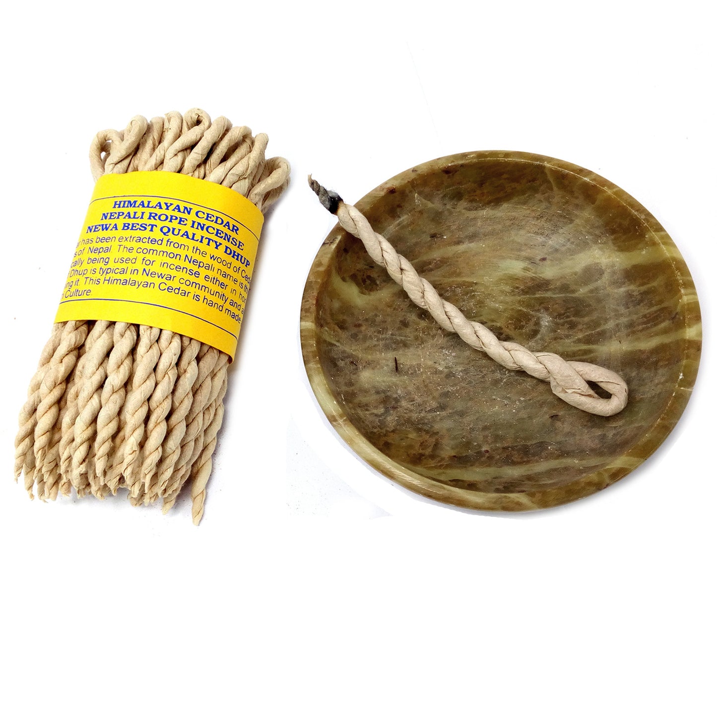 A bundle of twisted rope incense with a yellow label reads: "HIMALAYAN CEDAR NEPALI ROPE INCENSE NEPAL BEST QUALITY." One incense burns on a round, brownish holder.