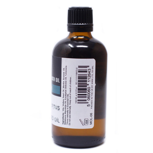 Brown glass bottle with a black ribbed cap sits on a white surface with a label stating "Ingredients: Vitis Vinifera Seed Oil, Mentha Arvensis Oil, Melaleuca Alternifolia Oil, Eucalyptus Globulus Oil, *Limonene," and has a barcode.