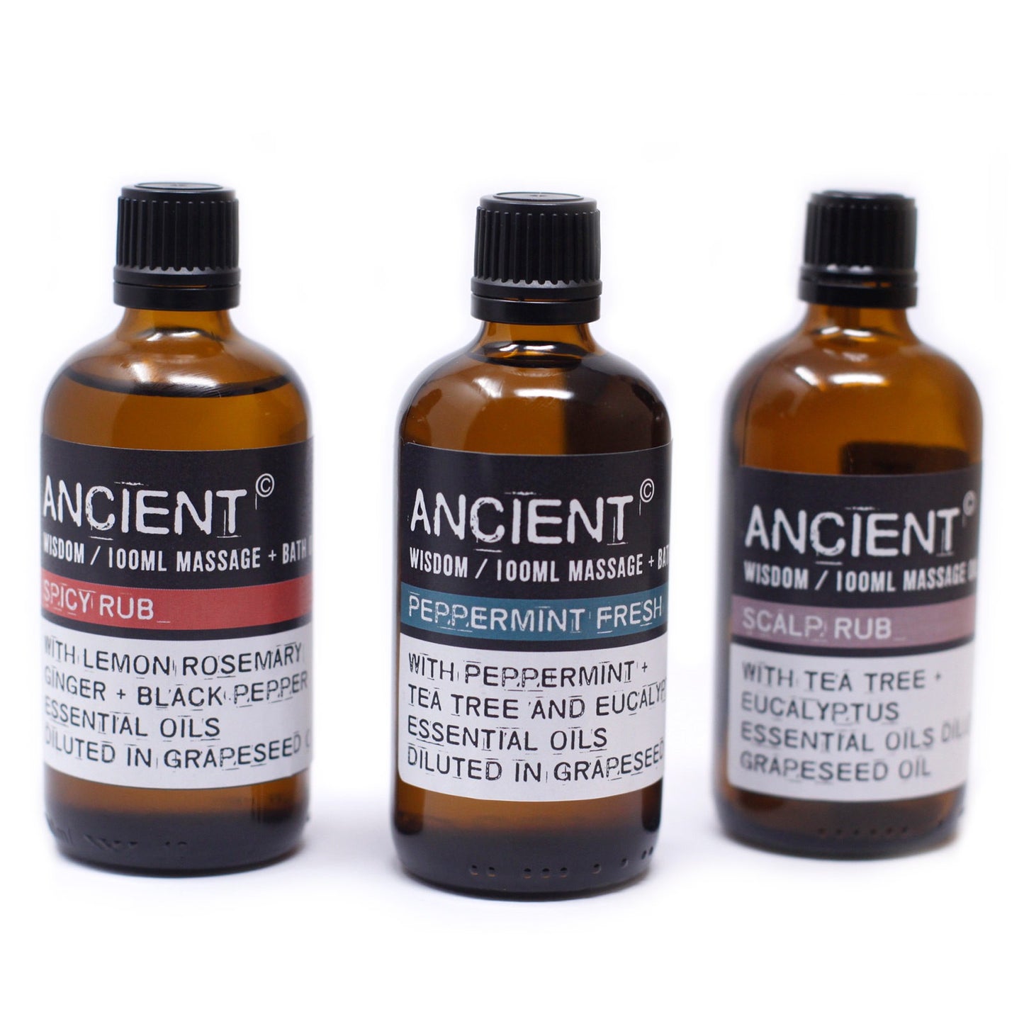 Three brown glass bottles stand against a bright white background. Each bottle is labeled "ANCIENT Wisdom/100ML Massage + Bath" followed by "SPICY RUB," "PEPPERMINT FRESH," and "SCALP RUB." The labels also list essential oils and that they are “diluted in grapeseed.”