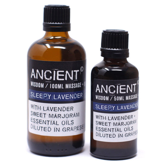Two brown bottles labeled "ANCIENT WISDOM / 100ML MASSAGE+ SLEEPY LAVENDER WITH LAVENDER SWEET MARJORAM ESSENTIAL OILS DILUTED IN GRAPESE" and "ANCIENT WISDOM / 50ML MASSAGE SLEEPY LAVENDER WITH LAVENDER + SWEET MARJORAM ESSENTIAL OILS DILUTED IN GRAPES" stand on a white surface.
