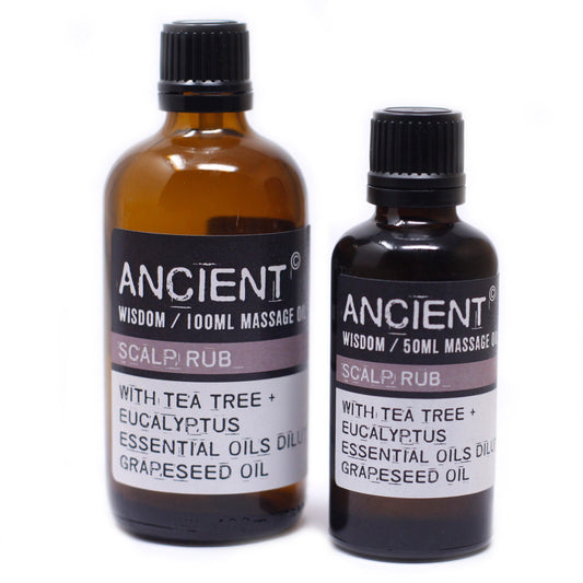 Two bottles of "ANCIENT" massage oil sit in front of a white background. The labels read, "ANCIENT WISDOM / 100ML MASSAGE OIL SCALP RUB WITH TEA TREE + EUCALYPTUS ESSENTIAL OILS GRAPESEED OIL" and "ANCIENT WISDOM / 50ML MASSAGE OIL SCALP RUB WITH TEA TREE + EUCALYPTUS ESSENTIAL OIL'S GRAPESEED OIL".