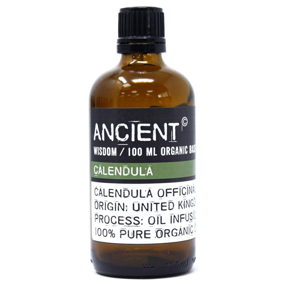 A brown glass bottle of "ANCIENT" calendula oil sits on a white surface. Text on the label reads "ANCIENT. WISDOM / 100 ML ORGANIC BASE. CALENDULA. CALENDULA OFFICINAL. ORIGIN: UNITED KINGDOM. PROCESS: OIL INFUSION. 100% PURE ORGANIC".
