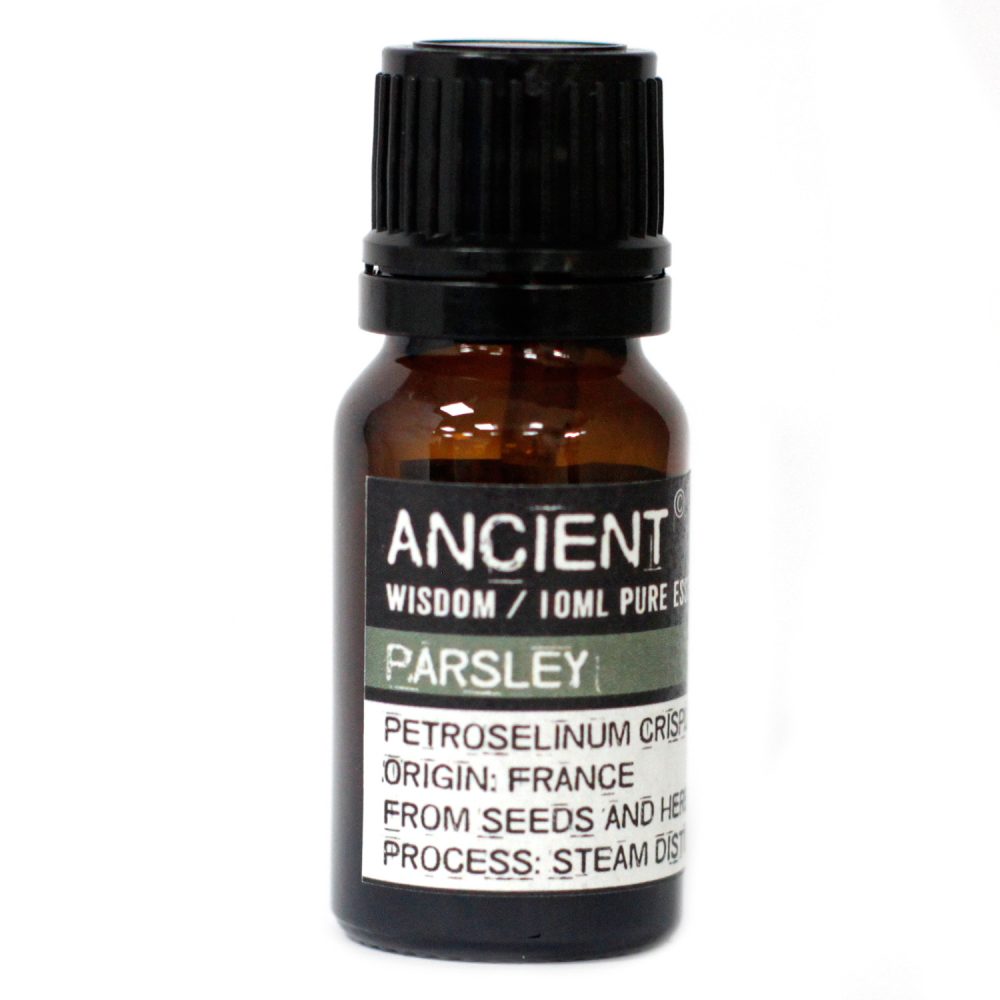 A small brown bottle is displayed on a white surface. The bottle is labeled "ANCIENT WISDOM / 10ML PURE ES," "PARSLEY," "PETROSELINUM CRISP," "ORIGIN: FRANCE," "FROM SEEDS AND HER," and "PROCESS: STEAM DIS".
