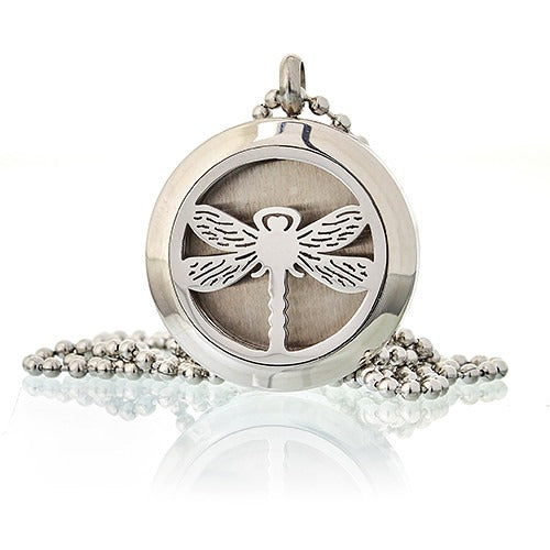 A circular, silver pendant shows a dragonfly design. The pendant dangles on a beaded chain against a glossy white background.