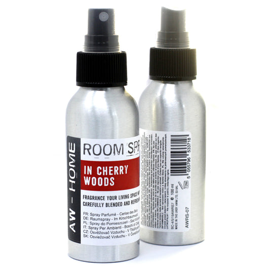 Two silver spray bottles, dispensing room fragrance, sit on a white background. The label reads: "ROOM SPRAY IN CHERRY WOODS," "FRAGRANCE YOUR LIVING SPACE WITH," and multilingual descriptions of the product.