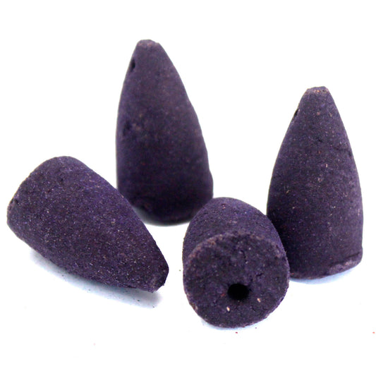 Four purple incense cones, with conical shapes and flat bases, are positioned on a white background. The cones have a rough texture and small holes at their bases.