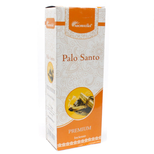 A rectangular box labeled "Aromatika Palo Santo Premium Incienso," featuring an orange and white design with a decorative pattern. An image of burning incense sticks is displayed on the front.