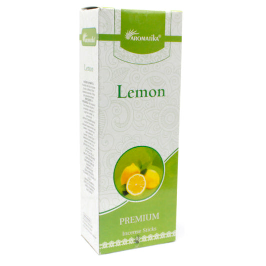 Box depicting lemon incense sticks, standing upright. Text reads: "AROMATIKA Lemon PREMIUM Incense Sticks," with an image of lemons and green leafy design.