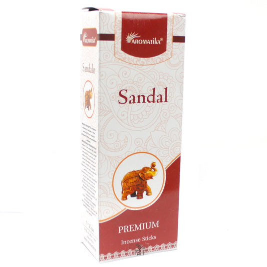 A rectangular box displays "AROMATIKA," "Sandal," and "PREMIUM Incense Sticks." It features an elephant illustration on a patterned background, blending white and maroon colors.