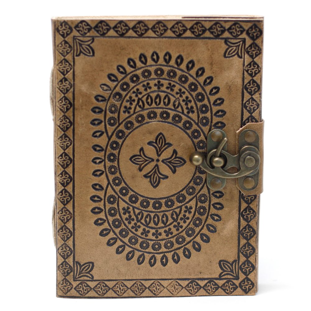 A leather-bound journal, light brown and patterned with a dark blue floral design, is fastened shut by a tarnished brass clasp, set against a plain white background.