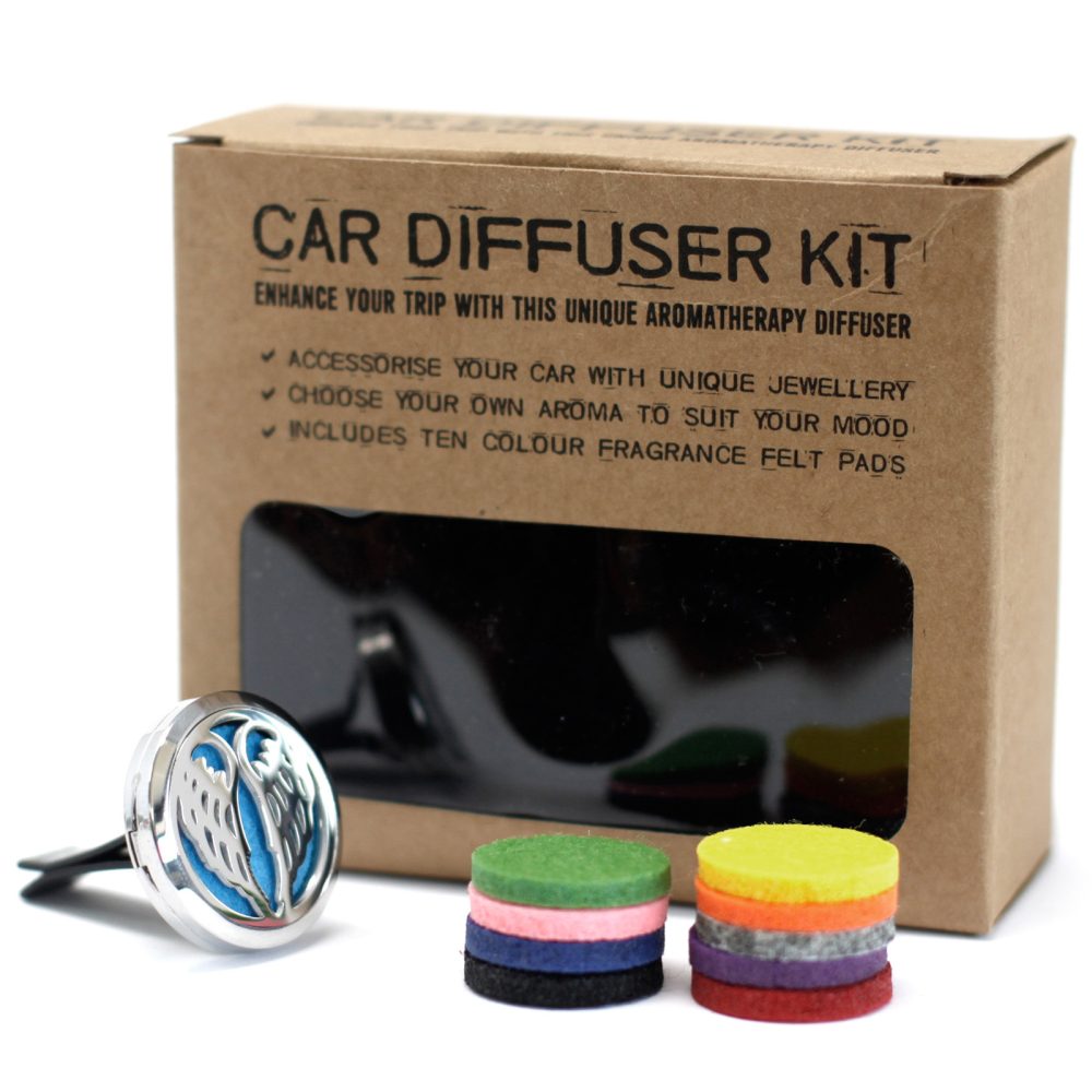 "CAR DIFFUSER KIT," in a box, with the text: "ENHANCE YOUR TRIP WITH THIS UNIQUE AROMATHERAPY DIFFUSER, ACCESSORISE YOUR CAR WITH UNIQUE JEWELLERY, CHOOSE YOUR OWN AROMA TO SUIT YOUR MOOD, INCLUDES TEN COLOUR FRAGRANCE FELT PADS." A diffuser and colorful felt pads sit nearby.