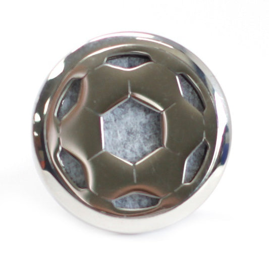 A metal sphere, resembling a soccer ball design with gray material showing through, is centered on a white surface.