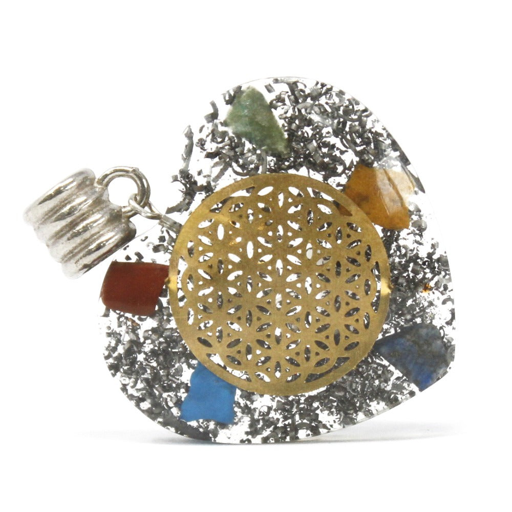A pendant features a clear resin body inlaid with metal shavings, colored stones, and a golden mandala-patterned disk. A silver-colored bail is attached, all on a white background.