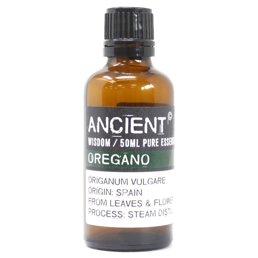 A bottle of “ANCIENT” brand Oregano essential oil sits on a white surface. Text on the label reads: “ANCIENT WISDOM / 50ML PURE ESSENT OREGANO ORIGANUM VULGARE ORIGIN: SPAIN FROM LEAVES & FLOWER PROCESS: STEAM DISTIL”.
