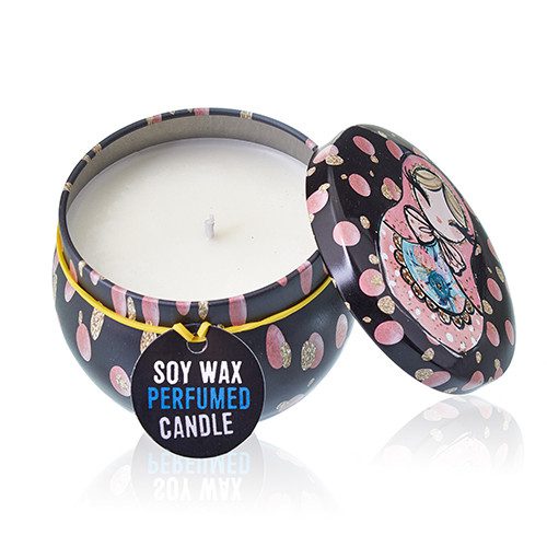 Round decorative tin candle displays white soy wax and wick, lid leaning beside it on a reflective white surface, tag reads "SOY WAX PERFUMED CANDLE"
