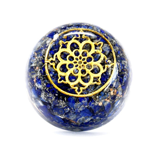 A polished, blue lapis sphere displays a golden, flower-like design on top. The background is plain white.