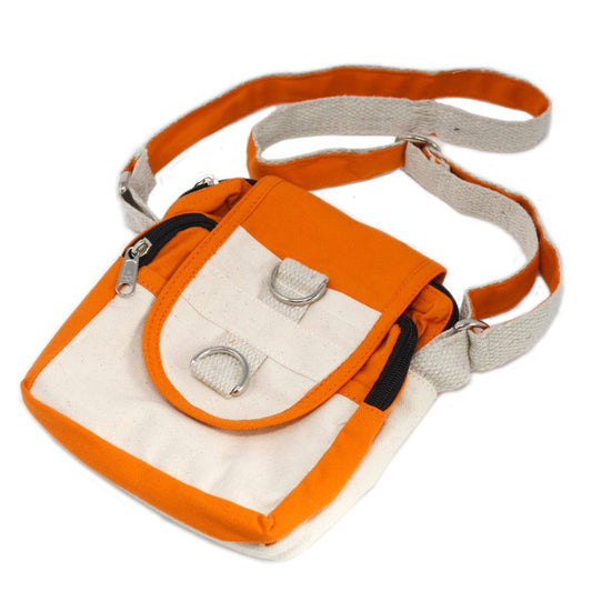 An orange and off-white canvas shoulder bag with silver metal details lays flat, displaying its flap pocket and zipper closures against a white background.