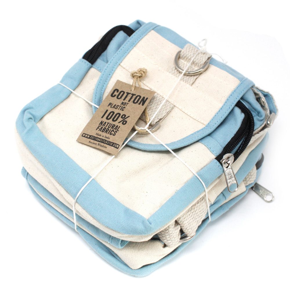 A stack of small, square, natural canvas bags with light blue trim sit tied with white string. A tag reads “COTTON NOT PLASTIC 100% NATURAL FABRICS Made in India WWW.COTTONNOTPLASTIC.COM Ancient Wisdom”.