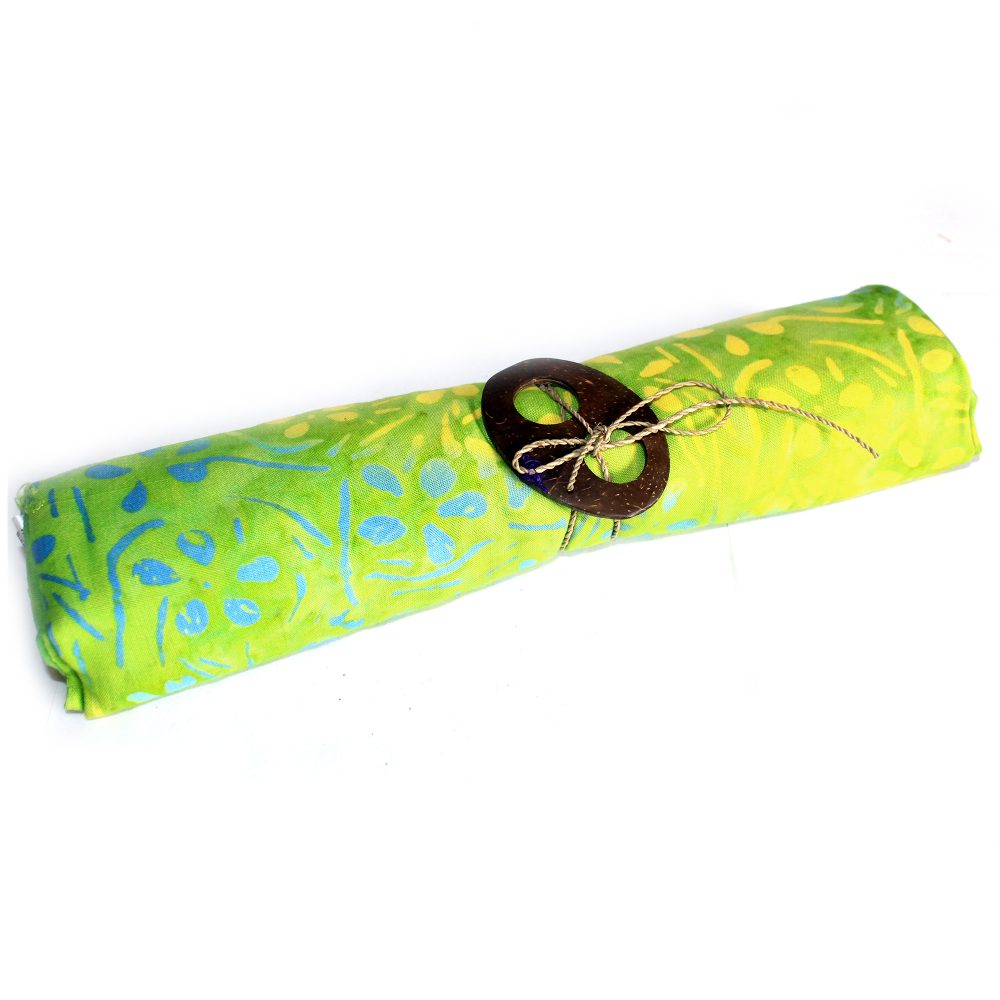 A lime green fabric, patterned with lighter green and blue, is rolled and tied with a coconut shell clasp. It rests on a white background.