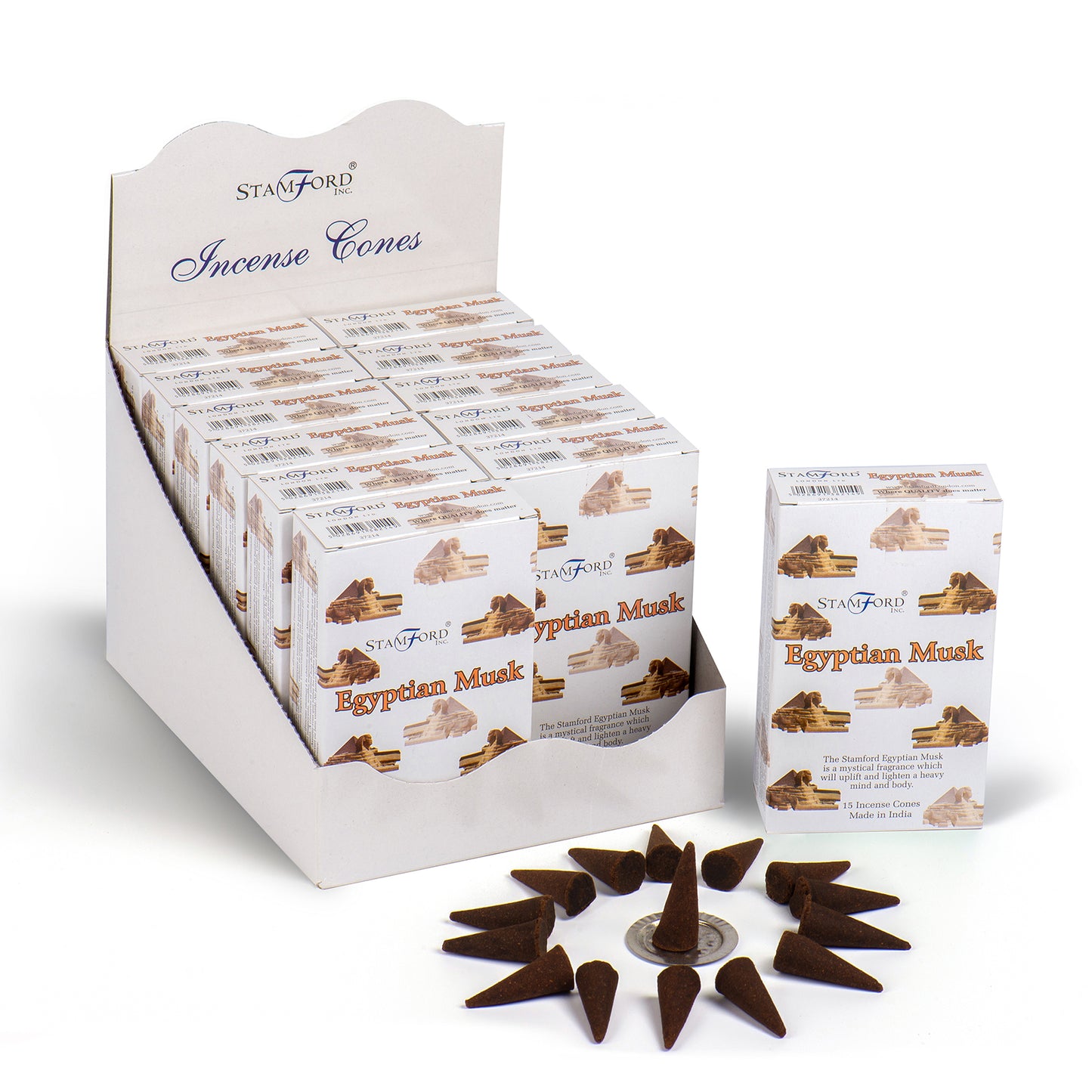 The image shows a display box with multiple packages of "Stamford Inc. Egyptian Musk" incense cones. One package is placed outside next to a circle of brown incense cones. Text: "Stamford Incense Cones Egyptian Musk The Stamford Egyptian Musk will uplift and balance your mind with its fine heavy musky aroma. 15 Incense Cones Made in India."