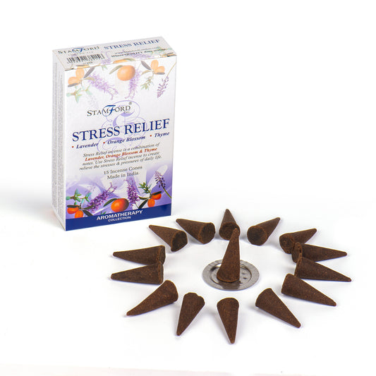 Incense cones encircle a metal stand beside a box labeled "STAMFORD Stress Relief," featuring lavender, orange blossom, and thyme illustrations. Box text: "15 Incense Cones Made in India Aromatherapy Collection."