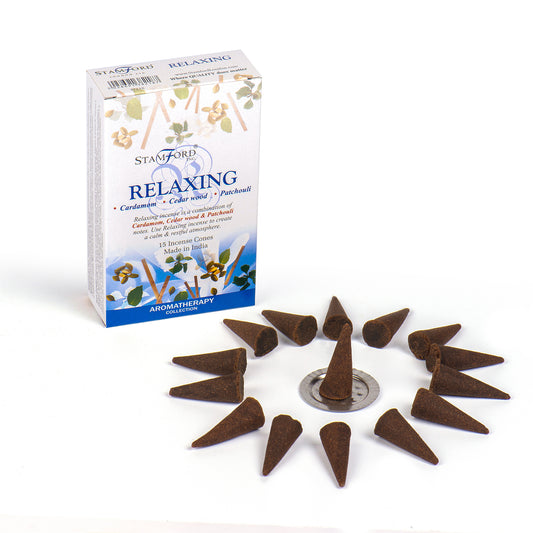 Incense cones encircle a metallic holder. A nearby box labeled "Stamford Relaxing" features floral illustrations, highlighting cardamom, cedarwood, and patchouli. Text: "15 Incense Cones Made in India Aromatherapy Collection."