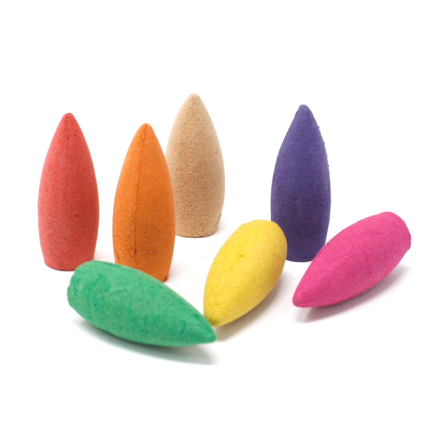 Seven colorful cone-shaped incense sticks stand or lie on a white surface. They are red, orange, beige, purple, green, yellow, and pink, arranged casually.