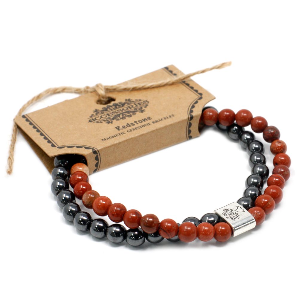 Two beaded bracelets circle atop a white surface, attached to a tag. The tag reads, "Accessories, Redstone, Magnetic Gemstone Bracelet". One bracelet is red, one is gray.