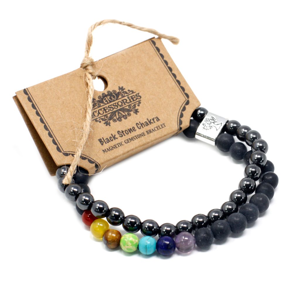 Two gemstone bracelets sit next to a tag on a white surface. The tag reads: “Accessories” “Black Stone Chakra” “MAGNETIC GEMSTONE BRACELET”.