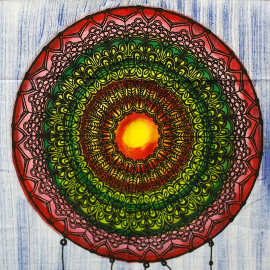 A mandala, painted in concentric circles of red, green, and yellow, hangs against a blue background.