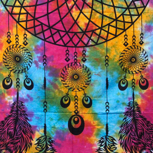 A tie-dye tapestry displays multiple dreamcatchers hanging; the dreamcatchers are black against a vibrant, swirling background of pinks, oranges, yellows, and blues.