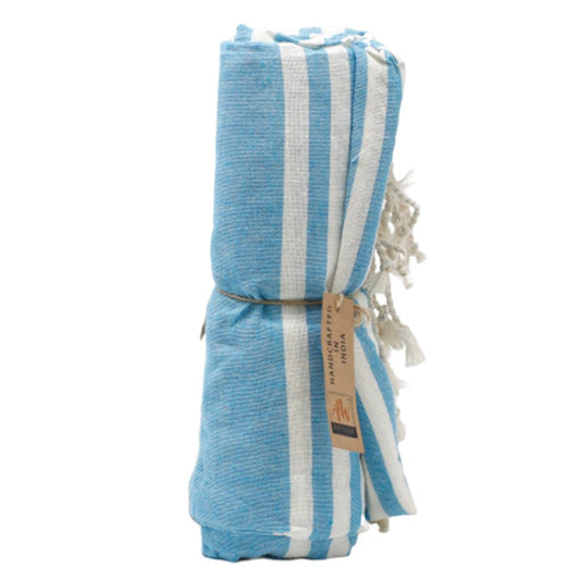 A blue and white striped towel is rolled and tied with twine. A tag reads "HANDCRAFTED IN INDIA".