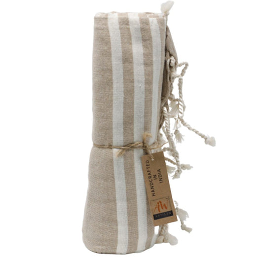 A tan and white striped towel is rolled and tied with twine. A tag reads, "HANDCRAFTED IN INDIA" and displays a logo.