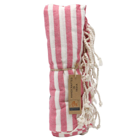 A pink and white striped towel is rolled and tied with twine. A tag reads "HANDCRAFTED IN INDIA".