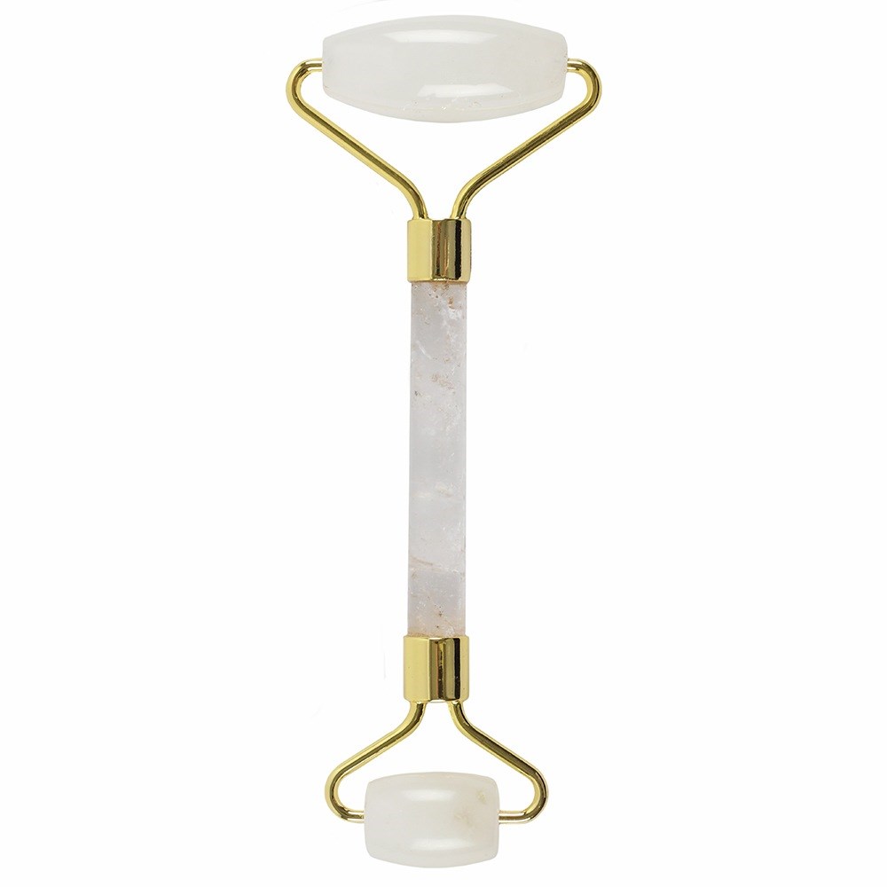 A white jade facial roller with a gold handle stands upright. The background is plain white.