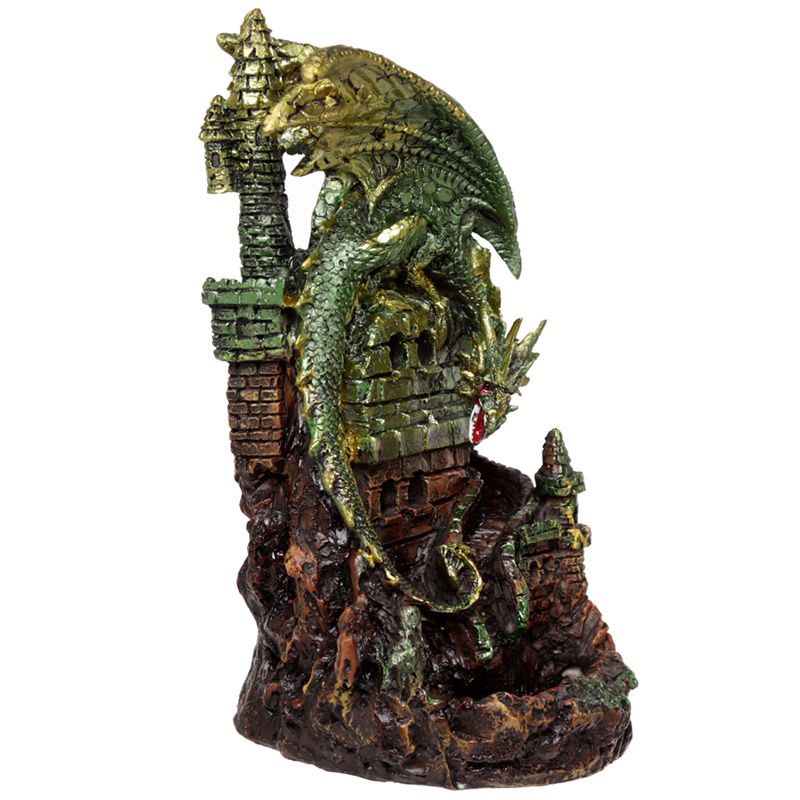 A green dragon figurine clings atop a medieval castle tower, wrapping around its stone structure. The setting includes rocky terrain with additional smaller turrets, providing a fantasy atmosphere.