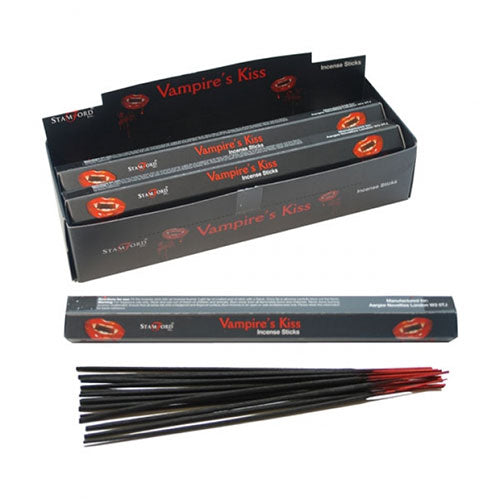 Incense sticks called "Vampire's Kiss" lie next to their packaging. The black and red boxes display vampire-themed graphics. Text includes: "STAMFORD," "Incense Sticks," and "Manufactured in India."
