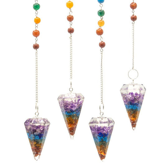 Four chakra pendulums hang from silver chains with colorful beads, displayed against a white background. The pendulums are diamond-shaped and filled with colorful stones, arranged in layers.