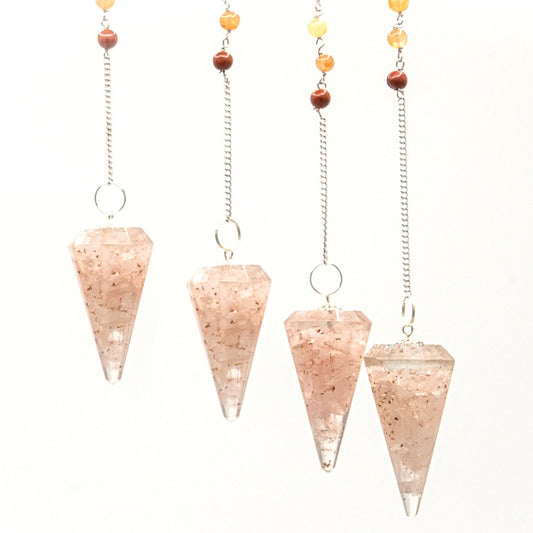 Four quartz pendulums hang by silver chains from beaded strands. The pendulums are cone-shaped and speckled with rose-colored inclusions against a white backdrop.