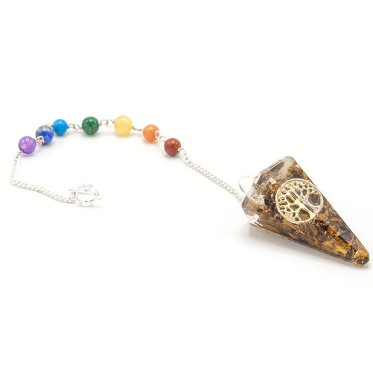 A pendulum, shaped like a cone with a "tree of life" symbol, is attached to a chain with colorful beads on a white background.