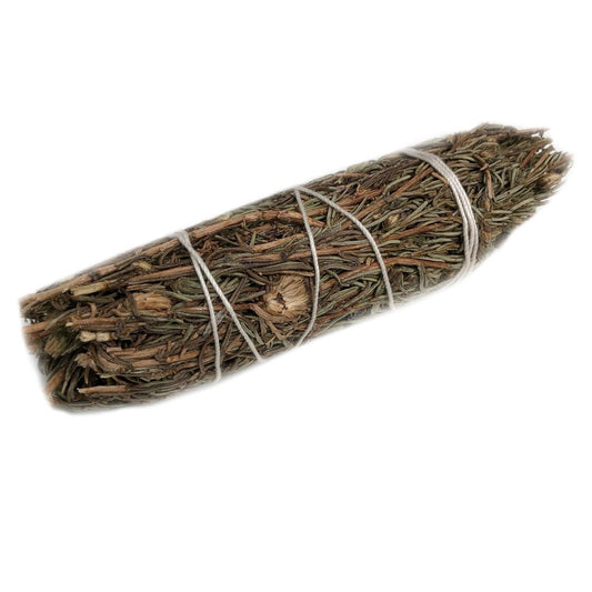 A bundle of dried herbs is tightly bound with white string, lying diagonally across a white background.