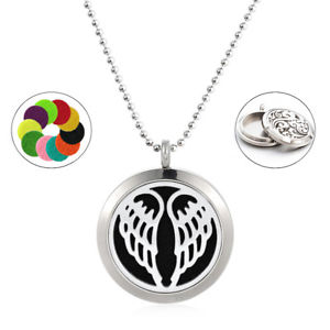 A silver locket necklace, featuring a pair of etched wings, hangs against a white background. It displays an open locket showing a felt pad, and a separate image showing a selection of colorful felt pads.